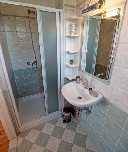 a bathroom with a sink and a shower at Villa Ana in Rab