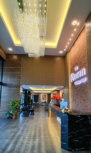 a large lobby with a chandelier in a hotel at The Room Boutique Hotel in Sakon Nakhon