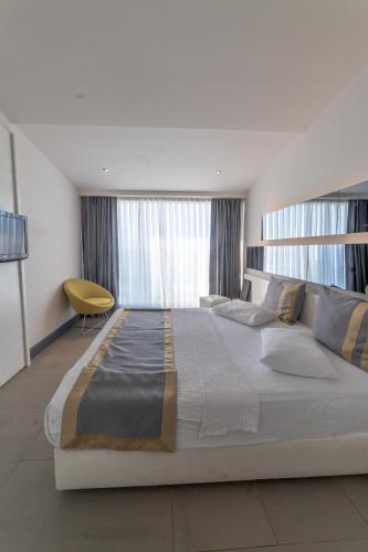 a large white bed in a room with windows at Atik Hotel in Unye