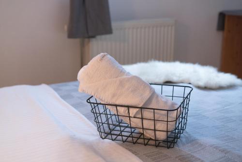 a basket filled with towels sitting on a bed at Brunarica in Bohinj