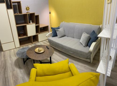 a living room with a couch and a table at In the heart of Odessa in Odesa