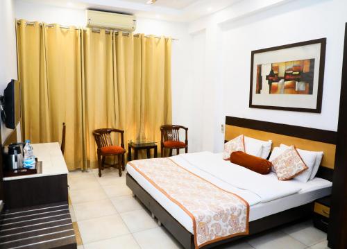a bedroom with a bed and a table and chairs at Indee home in New Delhi