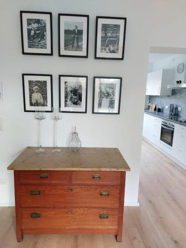 a kitchen with a wooden dresser and framed pictures on the wall at Landpartie in Freckenfeld