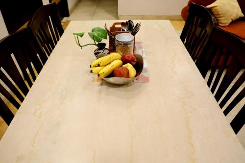 a table with a bowl of fruit on it at Indee home in New Delhi