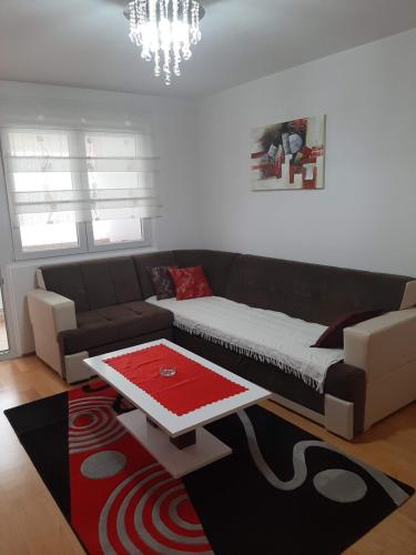 a living room with a couch and a coffee table at Apartman Neda in Kupres