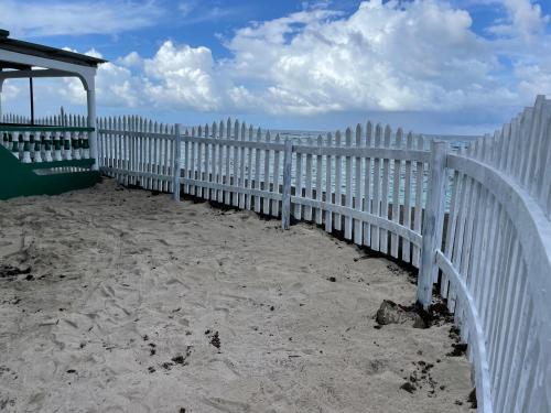 a white picket fence on the beach at The Wave Hostel Corn Island in Corn Island