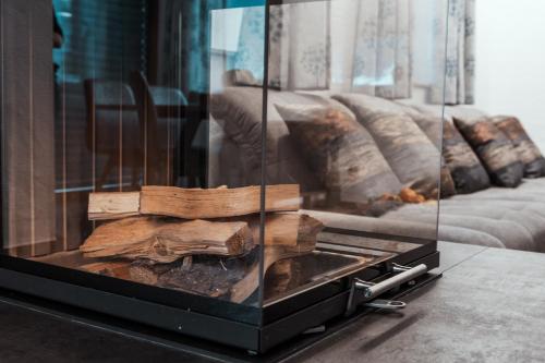 a display case with wooden logs on a table at Bergkristall in Gosau