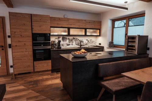 a kitchen with a island with a bowl of fruit on it at Bergkristall in Gosau