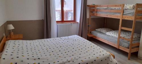 - une petite chambre avec 2 lits superposés et une fenêtre dans l'établissement Chambre à louer à la nuitée, à Lanslebourg-Mont-Cenis
