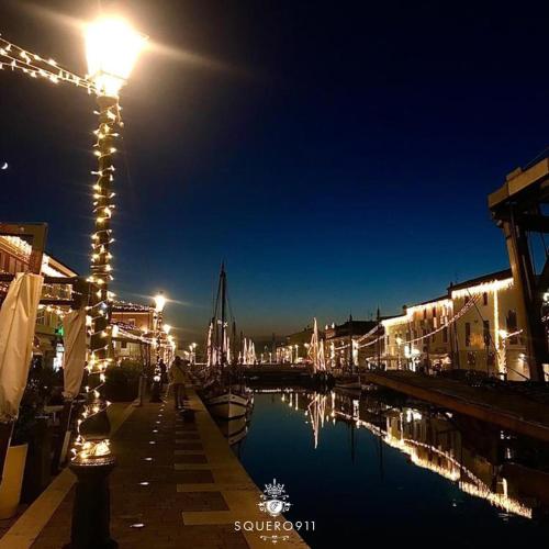 a street light next to a canal at night at ca' squero911 luxury rooms in Cesenatico