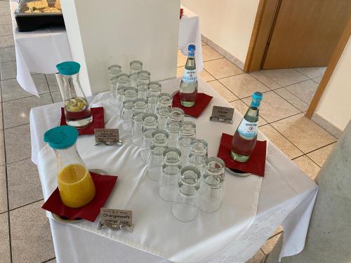a table with wine bottles and glasses on it at Hotel garni St.Georg in Sankt Wolfgang