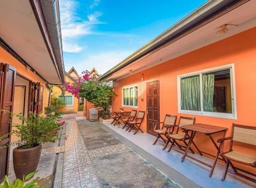 a patio with chairs and tables on a building at MANDARIN LODGE by victor in Hua Hin