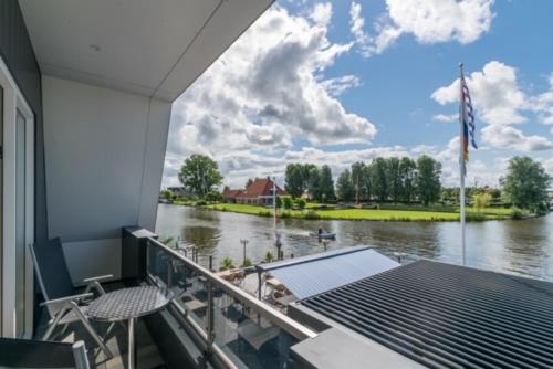 a view of a river from the balcony of a boat at Appartementen De Helling 44 in Heeg