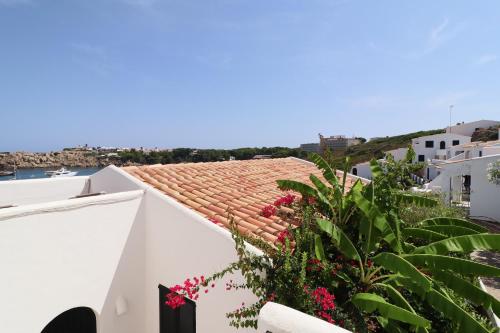 a view from the balcony of a house with pink flowers at Belvedere, Family-friendly, Nice, First-line Apartment with Stunning Beach and Sea views,AC in Arenal d'en Castell