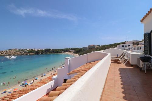 a view of the beach from the balcony of a building at Belvedere, Family-friendly, Nice, First-line Apartment with Stunning Beach and Sea views,AC in Arenal d'en Castell