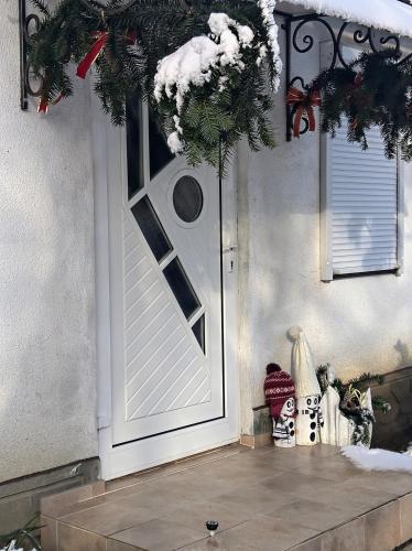 a white door with a christmas wreath on it at Hotel Окремий Будинок-Апартаменти in Rakoshyno