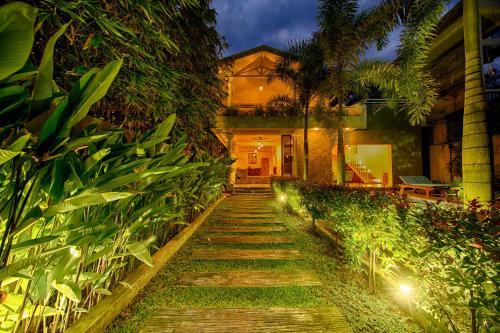 a stone path leading to a house with lights at Deltora Villa - free drop off to Galle Fort by TukTuk in Galle