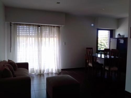 a living room with a couch and a table and a window at Villa Elisa, La Plata, Apart in Villa Elisa