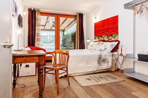 a bedroom with a bed and a desk and a table and chair at A Room for You in Ferrara