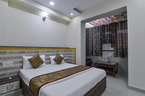 a bedroom with a bed and a stained glass window at Hotel Aroma- Dadar in Mumbai