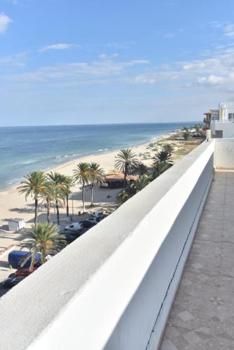 a view of the beach from the balcony of a resort at Dar Marrakech Apartment Sousse in Hammam Sousse