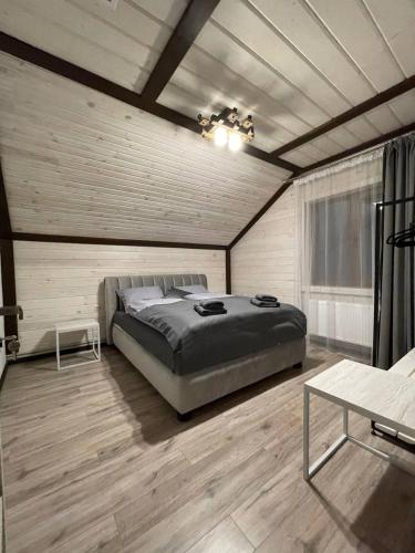 a bedroom with a large bed in a room at Happy House in Slavske