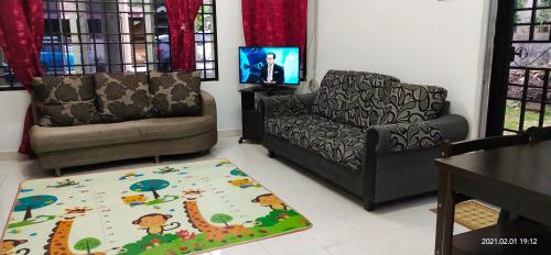 a living room with two chairs and a couch and a rug at AziziYati Muslem Homestay KLIA Sepang - SemiD House in Sepang