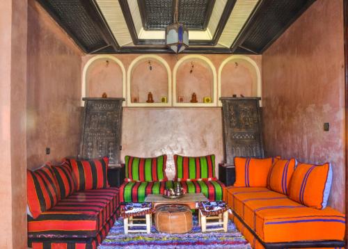 a living room with two couches and a table at Toubkal Ecolodge in Imlil