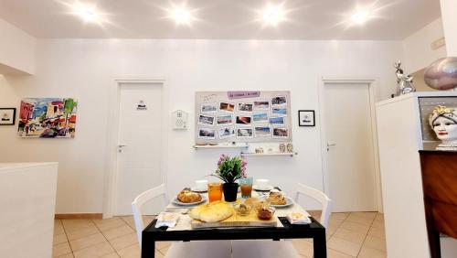a dining room with a table with food on it at Zanzibar - Charming Rooms and Apartments in Avola