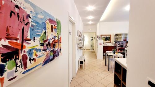 a hallway with colorful paintings on the wall at Zanzibar - Charming Rooms and Apartments in Avola