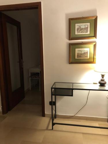 a room with a glass table and a door at La Pigna Verde in Taranto