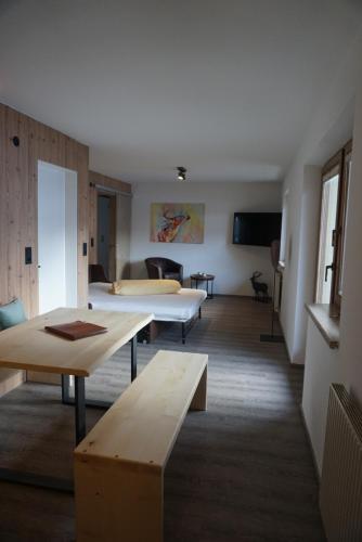 a hotel room with two beds and a couch at Apart&Chalet Chiara in Neustift im Stubaital