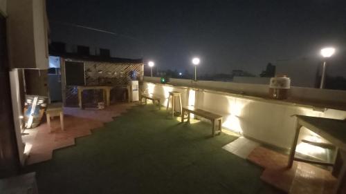 a room with benches on a roof at night at Sprinklers in New Delhi