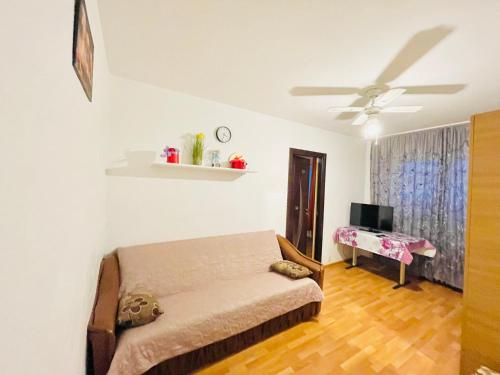 a bedroom with a bed and a desk in it at Cozy Apartments in Bacău