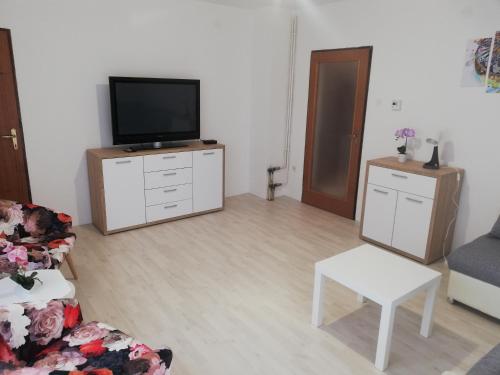 a living room with a flat screen tv on a dresser at Apartments Mateo in Zagreb