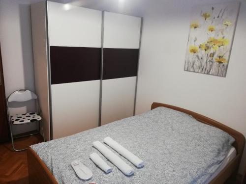 a room with a bed with three remote controls on it at Apartments Mateo in Zagreb