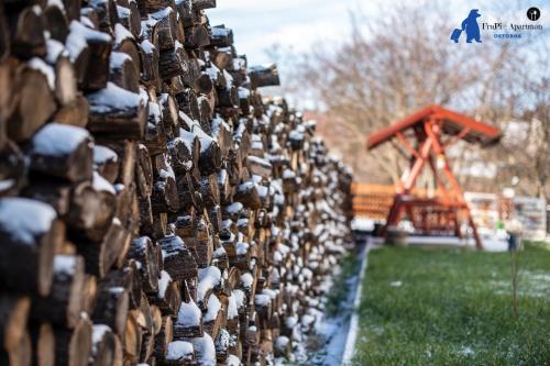 a fence covered in padlocks with a snow coveredustedescription at FruPi-Apartmanok in Ostoros