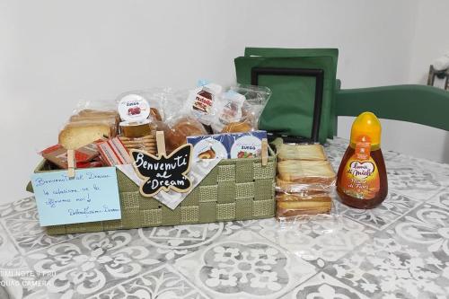 a table with a basket of food and a bottle of mustard at Dream- appartamento ristrutturato a Genova in Genova