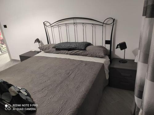 a bedroom with a bed with a metal headboard at Dream- appartamento ristrutturato a Genova in Genova