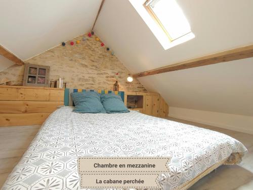 a bedroom with a large bed in a attic at La Maison Mescladis in Manhac