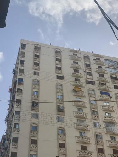 a tall building with balconies on the side of it at Sea View Paradise in Alexandria