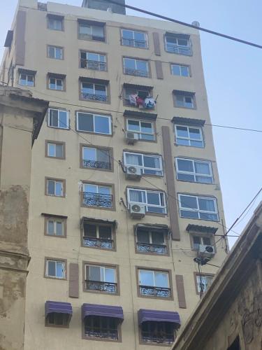 an apartment building with people in the balconies at Downtown Sea View Suites in Alexandria
