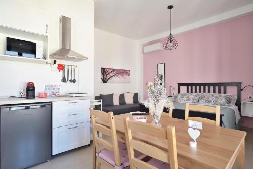 a kitchen and living room with a table and a dining room at Family Room Scicli in Scicli
