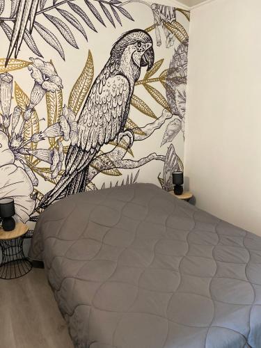 - une chambre avec une fresque murale représentant un perroquet dans l'établissement Jm Vacances Serignan Studio, à Sérignan
