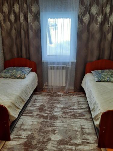 Ένα ή περισσότερα κρεβάτια σε δωμάτιο στο Guest house Vostochnaya 27