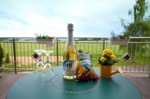 a bottle of champagne on a table on a deck at The Old Farmhouse in Edling