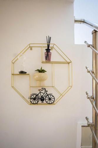 a glass shelf with a bike on a wall at Morak Homes - Luxury 4 bed home with PS5, 24hrs electricity, Super fast Wifi, Snooker, Games room - in a secured estate in Abuja