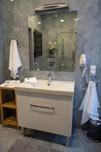 a bathroom with a sink and a mirror at Domki Asgard in Gąski