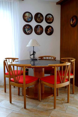 a dining room table and chairs with plates on the wall at 2 rooms Appartment "Home, Swiss Home" in Bilten