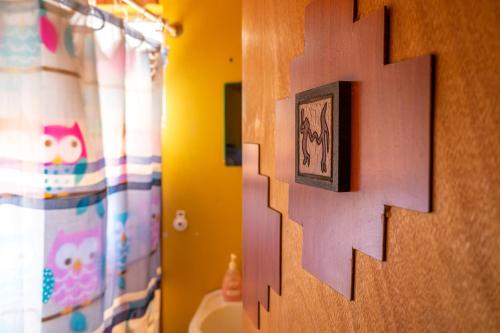 a bathroom with a picture on the wall at La Casa del Sol Naciente in San Pedro de Atacama